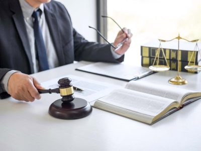 Judge gavel with Justice lawyers, Businessman in suit or lawyer working on a documents in courtroom. Legal law, advice and justice concept.