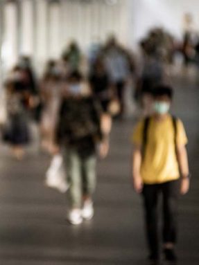 Crowd of people wearing mask walking in the new normal