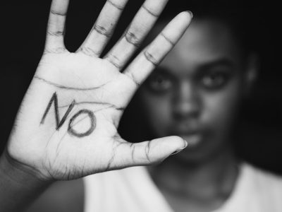 Closeup of girls hand with the word no