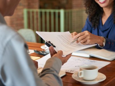 Businessman consulting with lawyer before signing contract