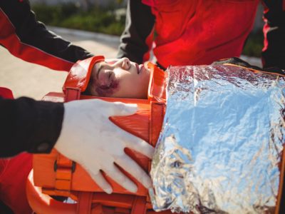 Injured woman treated by paramedic at accident spot